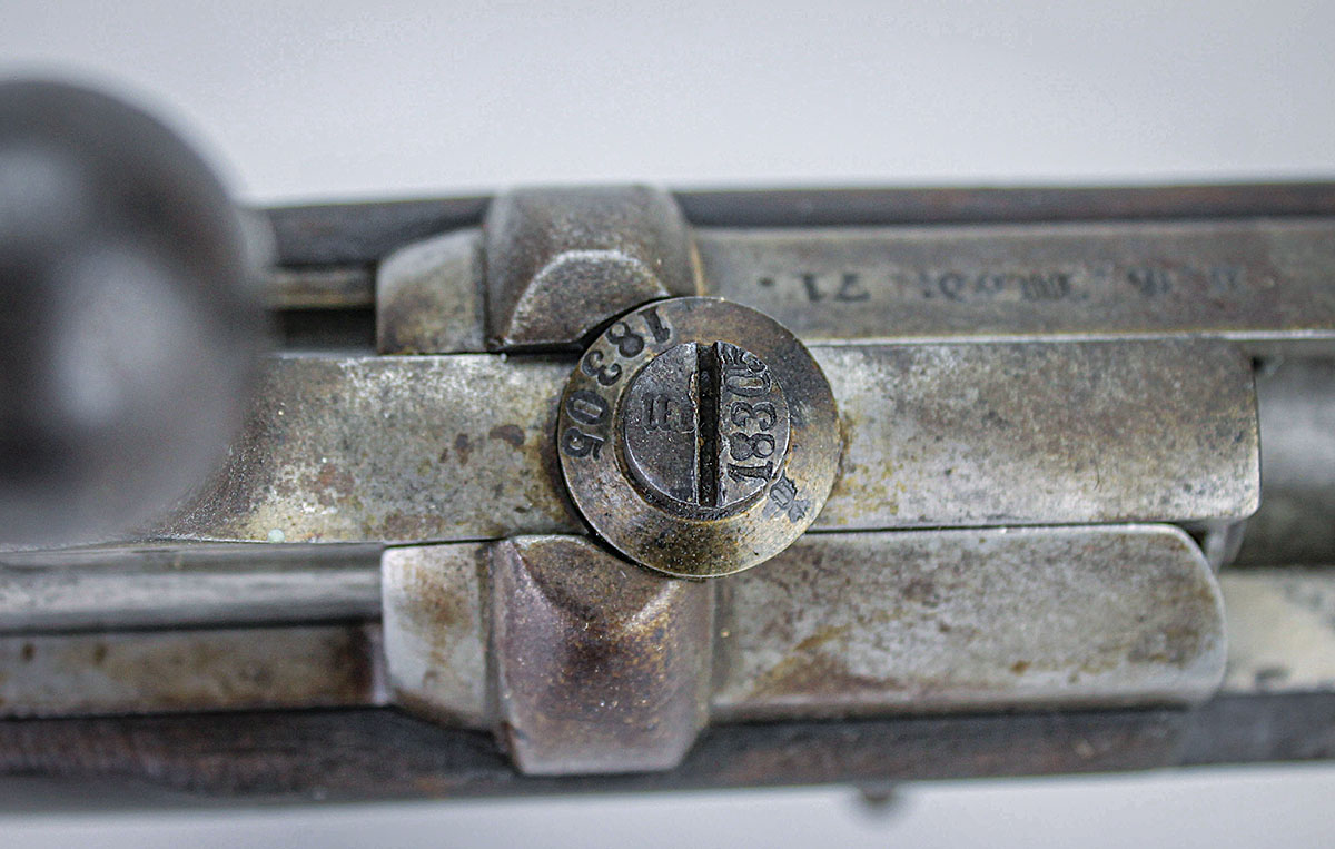 Screws, including the bolt stop screw, bear numbers matching the rifle’s serial number.